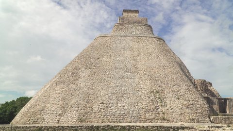 UXMAL, MEXICO - CIRCA 2021: The Pyramid of the Magician, a step pyramid and most recognizable landmark of Uxmal, an ancient Mayan city located on Yucatan peninsula