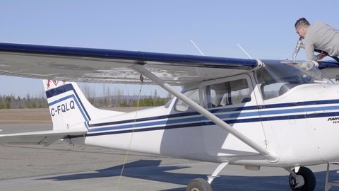 WILLIAMS LAKE , Canada - 05 21 2021: Airport Crew Refueling Cessna 172 Plane 
