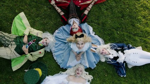 Munich , Germany - 09 25 2020: Aerial view of alice in wonderland cosplay. cosplayer in the characters of alice, the red queen, the white queen, the white rabbit and the crazy hatter