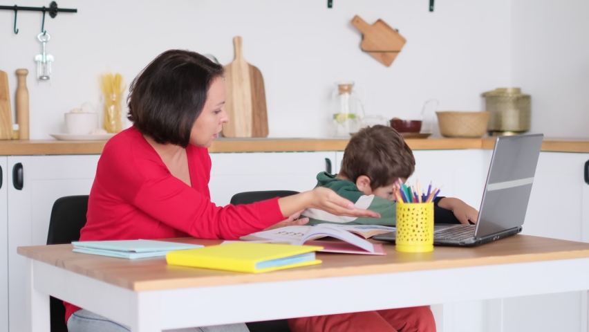angry serious mum lecturing lazy unmotivated schoolboy, children education problem, parent and child conflict. Stressed mother and son frustrated over failure homework. Royalty-Free Stock Footage #1079163236