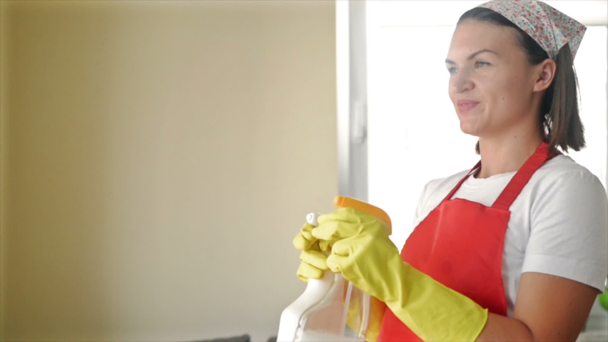 Tired of boring work, the housewife started a fun game with the Hand Sprayers. | Shutterstock HD Video #1079163614