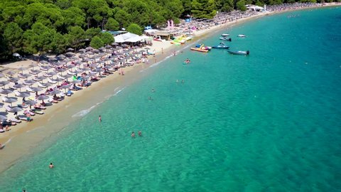 Beautiful Koukounaries beach on the island of Skiathos, Sporades, Greece, with emerald shining sea and lush vegetation on the surrounding hills