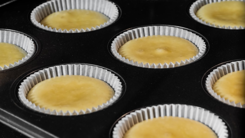 Timelapse - cupcakes, muffins baking and rising in muffin tin in electric oven in kitchen at home - close up view. Homemade bakery, food, cooking, pastry and time lapse concept Royalty-Free Stock Footage #1079177297