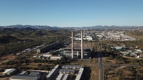 Windhoek, Namibia - 05.02.20: 4K bright summer morning aerial video of Van Eck coal-fired power station and its chimneys located in Windhoek Northern Industrial area, Khomas Region, southern Africa