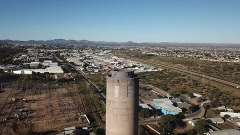 Windhoek, Namibia - 05.02.20: 4K bright summer morning aerial video of Van Eck coal-fired power station and its chimneys located in Windhoek Northern Industrial area, Khomas Region, southern Africa