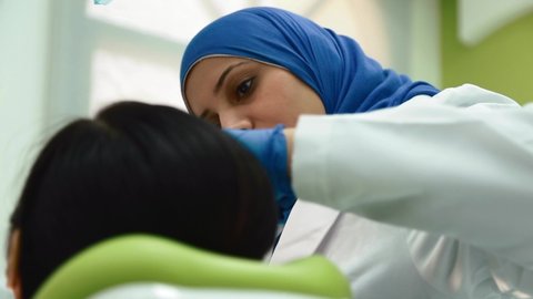 Dubai , United Arab Emirates - 09 12 2018: Female Muslim Dentist With Patient At The Dental Clinic