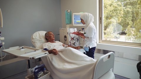 Beirut , Lebanon - 08 14 2018: Muslim Arab Woman Talking To A Patient Undergoing Dialysis Treatment