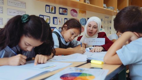 Dubai , United Arab Emirates - 09 19 2018: Teacher Wearing Hijab Teaching Arabic Language To Elementary Students In The Schoolのエディトリアル動画素材
