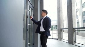 male asian businessman unlocking door using mobile phone application. Unlocks a modern office building. Scanning open smartphone with mock up screen app. smart electronic locks with keyless access - Powered by Shutterstock - Get 15% off with code: PIKWIZARD15