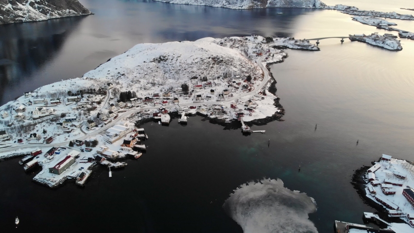 Aerial view, Scandinavian fishing village with snow covered on coastline in Norwegian sea at Lofoten Islands, Norway