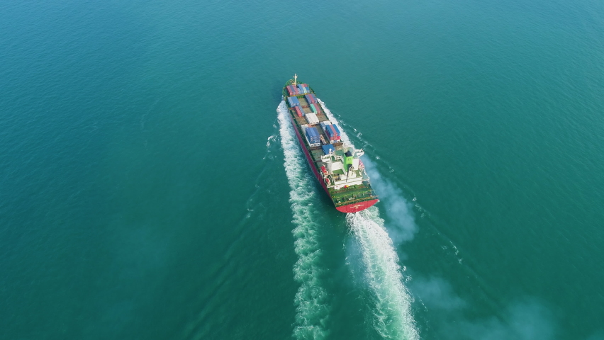 Container ship in export and import business and logistics. Shipping cargo to harbor by crane. Water transport International. Aerial view and top view. Royalty-Free Stock Footage #1079198219