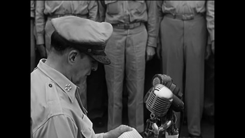 CIRCA 1945 - General MacArthur reads aloud Japan's instrument of surrender aboard the USS Missouri.