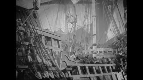 CIRCA 1937 - In this period piece set in Elizabethan England, a British ship pulls up alongside the Spanish armada and knights jump over to fight.