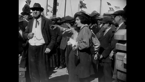 CIRCA 1914 - In this silent film, a woman (Charlie Chaplin in drag) punches out a cop so she can enjoy dancing at a harbor concert.