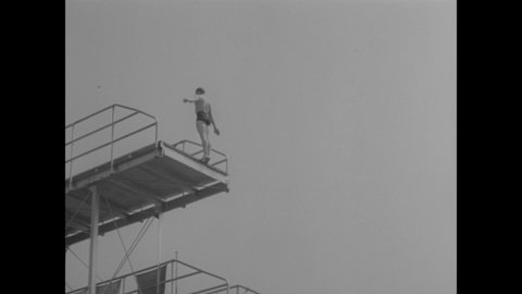 CIRCA 1949 - Slow motion is used to capture a diving competition at a Los Angeles swimming pool.