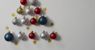 Video of christmas decorations with baubles and copy space on white background. christmas, tradition and celebration concept.
