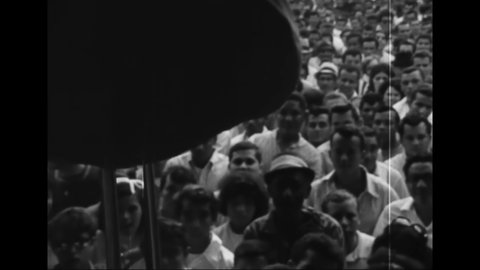CIRCA 1960s - Close-ups of excited audience members at an outdoor concert in a Hispanic neighborhood.
