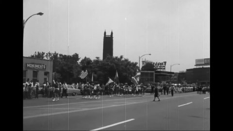 CIRCA 1960s - Hispanic Catholic school girls carry flags in a parade.