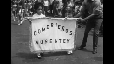CIRCA 1960s - A parade in a Hispanic neighborhood includes groups from Catholic schools.