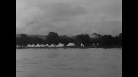 CIRCA 1944 - Chindit soldiers of British Special Forces build their camp along a river in Kamaing, Burma.
