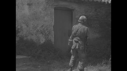 CIRCA 1944 - American paratroopers cautiously approach the outskirts of Le May, France, and find wounded civilians and soldiers.