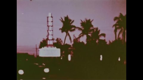 CIRCA 1959 - Patrons visit a drive-in theater in daylight and at nighttime.