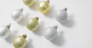 Video of christmas baubles and copy space on white background. christmas, tradition and celebration concept.