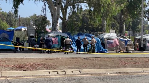 Law enforcement investigate the scene of a fatal stabbing at a homeless encampment in Brentwood area, near the West Los Angeles VA complex, in Los Angeles, Wednesday, Sept. 15, 2021. 