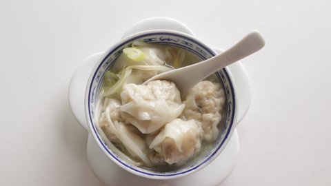 Chinese dumpling food, homemade wonton soup with scallion on top, shooting from high angle view