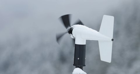 Wind anemometer of a weather station in winter with some snow
