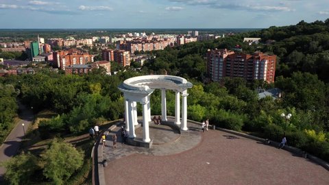 Poltava, Ukraine - 13 august 2021: White rotunda or Rotunda of friendship among peoples in Poltava city, Ukrainian landmark. Aerial view with cityscape