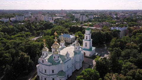Aerial view to The Assumption Cathedral and his bell tower in Poltava, orthodox church at summer lanscape with green trees