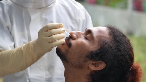 Tarakan, Indonesia, Sept 07,2021: An Indonesian Man Having Deep Nasal Nasopharyngeal Coronavirus COVID-19 PCR Swab Test During Pandemic
