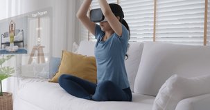 Asia girl teen people enjoy hobby happy deep zen remote learn sport play online fitness body gym class fit life. Relax joy lotus asana pose wear smart digital iot VR headset in AR app at home sofa.