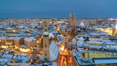 Aerial view of Munich City Germany at winter with snow, Cathedral Church of Our Lady (Frauenkirche) in munich old town Marienplatz. Munchen Skyline aerial view at morning. Munich night winter skyline.