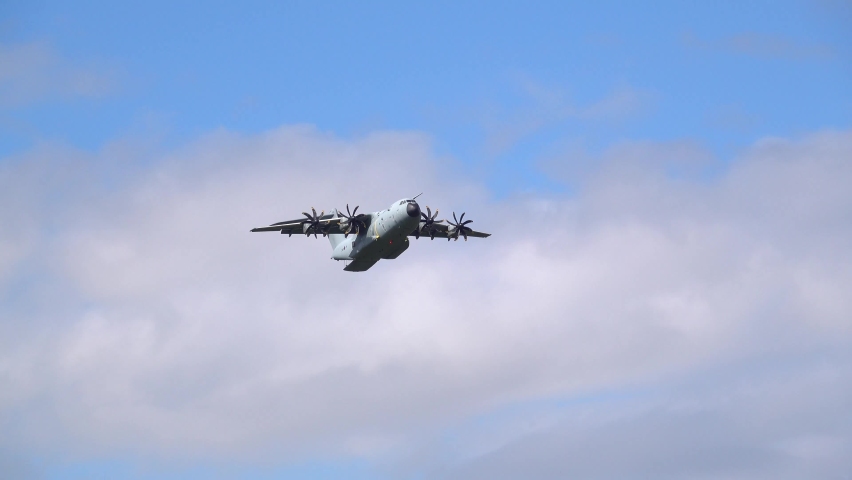 ZM401 RAF Royal Air Force Airbus A400M Atlas military cargo plane on a low-level cargo parachute drop exercise, blue sky light cloud Royalty-Free Stock Footage #1079250776