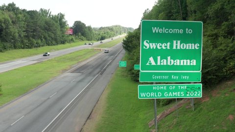 Tennessee Line , Alabama , United States - 08 10 2021: Welcome to Alabama. Sweet Home Alabama. Border with Georgia and Tennessee. Rising aerial.