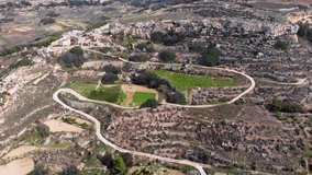 Gorgeous aerial drone video from west of Malta, Dingli area, showing the landscape, fields and traditional farmhouse in the background.