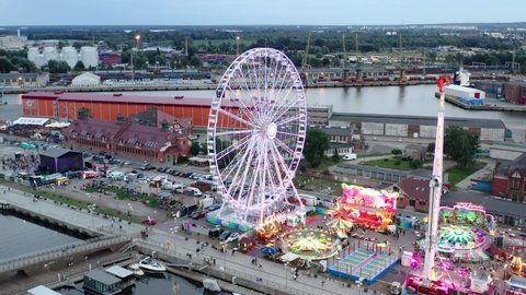 Szczecin , Poland - 08 11 2021: People Enjoying Amusement Rides At Holiday Park Szczecin Before Nightime