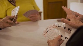 Old people playing cards at a retirement home. seniors having fun together with friends. Playing bridge and gossiping in the afternoon. Old people's house at card game time - Powered by Shutterstock - Get 15% off with code: PIKWIZARD15