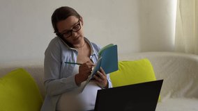 Successful hardworking Pregnant business Woman With Laptop. Young Ledy In Pregnancy speaks call by phone Work paperwork Remotely using Internet and Online Technology At Home. Maternity leave Concept - Powered by Shutterstock - Get 15% off with code: PIKWIZARD15