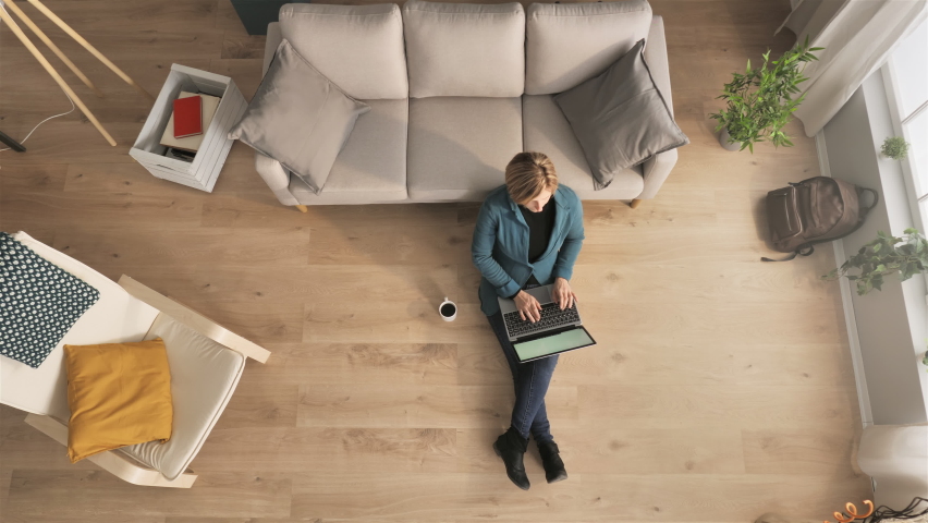 businesswoman sitting on floor works from home using computer top down view overhead,young business woman freelancer working remote typing on laptop above shot indoors,distance work concept Royalty-Free Stock Footage #1079261327