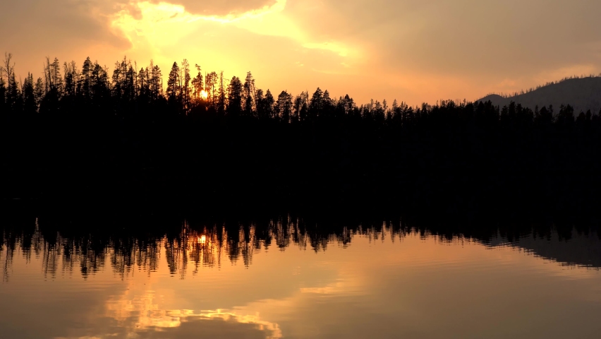 Vertical footage of sunset over a lake in the Yellowstone National Park
