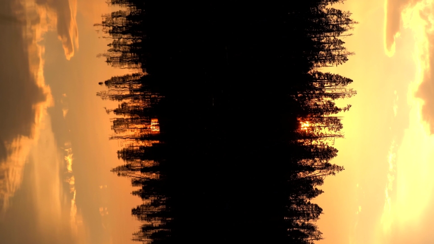 Vertical footage of sunset over a lake in the Yellowstone National Park