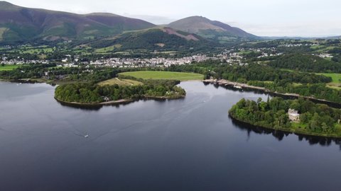Keswick town viewed over Derwent water Lake District Cumbria UK Summer aerial footage 