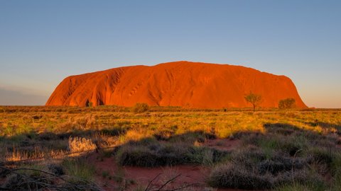 YULARA, AUSTRALIA - JUNE 7 2021: a close sunset timelapse of uluru in uluru-kata tjuta national park of the northern territory
