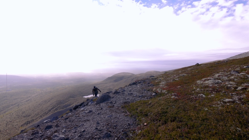 lonely traveler in the snowy mountains. Mountain tourism. Hiking and traveling
