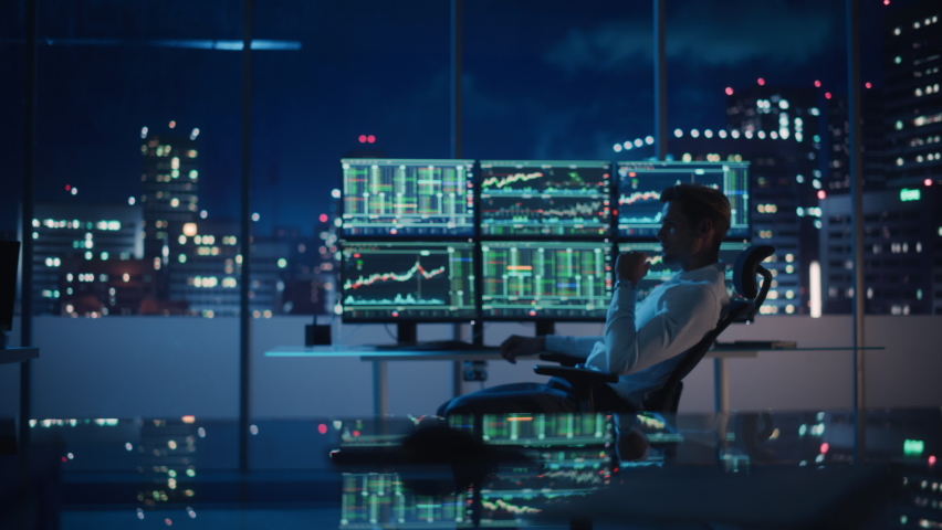 Financial Analyst Working on Computer with Multi-Monitor Workstation with Real-Time Stocks, Commodities and Exchange Market Charts. Businessman Deliberating on Next Investment Trade in a Bank Office. | Shutterstock HD Video #1079285513