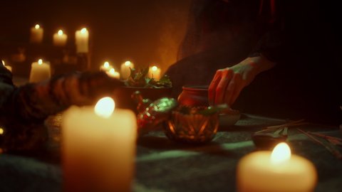 Witch woman sitting in pentagram circle and cooking potion. Evil sorceress making rite and sacrifices at night, using black witchcraft, cow skull and candles on floor. Halloween tradition, usa holiday