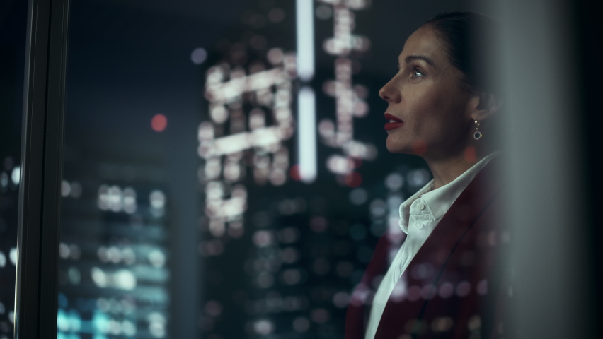 Successful Businesswoman in Stylish Suit Working on Top Floor Office Overlooking Night City. High Achievement Female CEO of Humanitarian Investment Fund, Human Face of Sustainable Corporate Governance | Shutterstock HD Video #1079293238